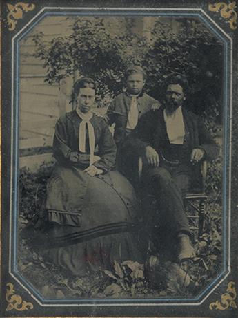 (PHOTOGRAPHY--EARLY AND CASED IMAGES.) Outdoor photograph of a seated, well-dressed, black man, with his white wife and their interraci